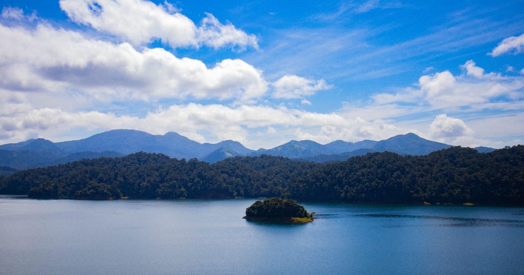 Small green island in the middle of a blue lake