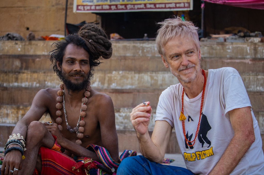 Sadhu sitting with tourist