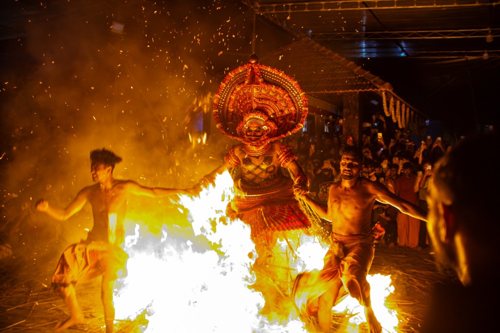 Theyyam dancers jumping through fire